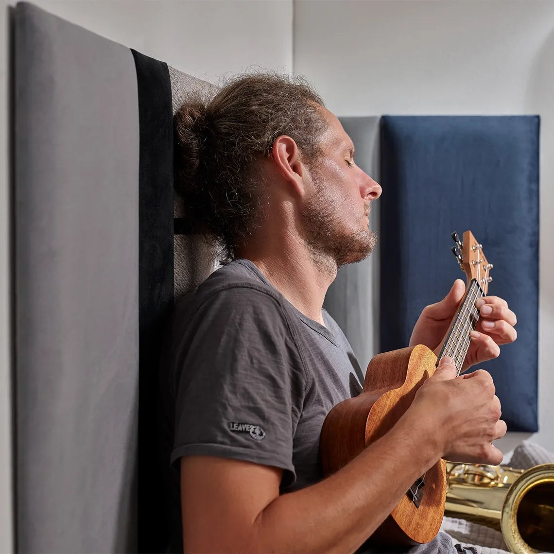 Padded Wall Panels Set 1 Grey in interior with a man playing instruments Decormania UK